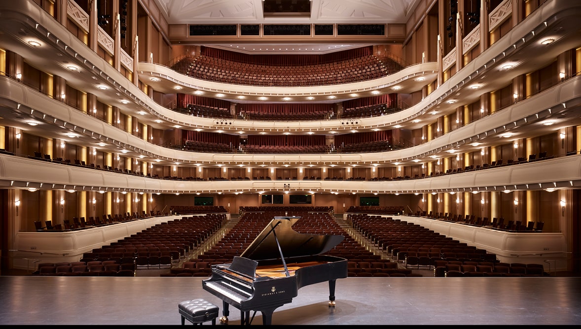 A photo of Reynolds Hall from stage with piano.